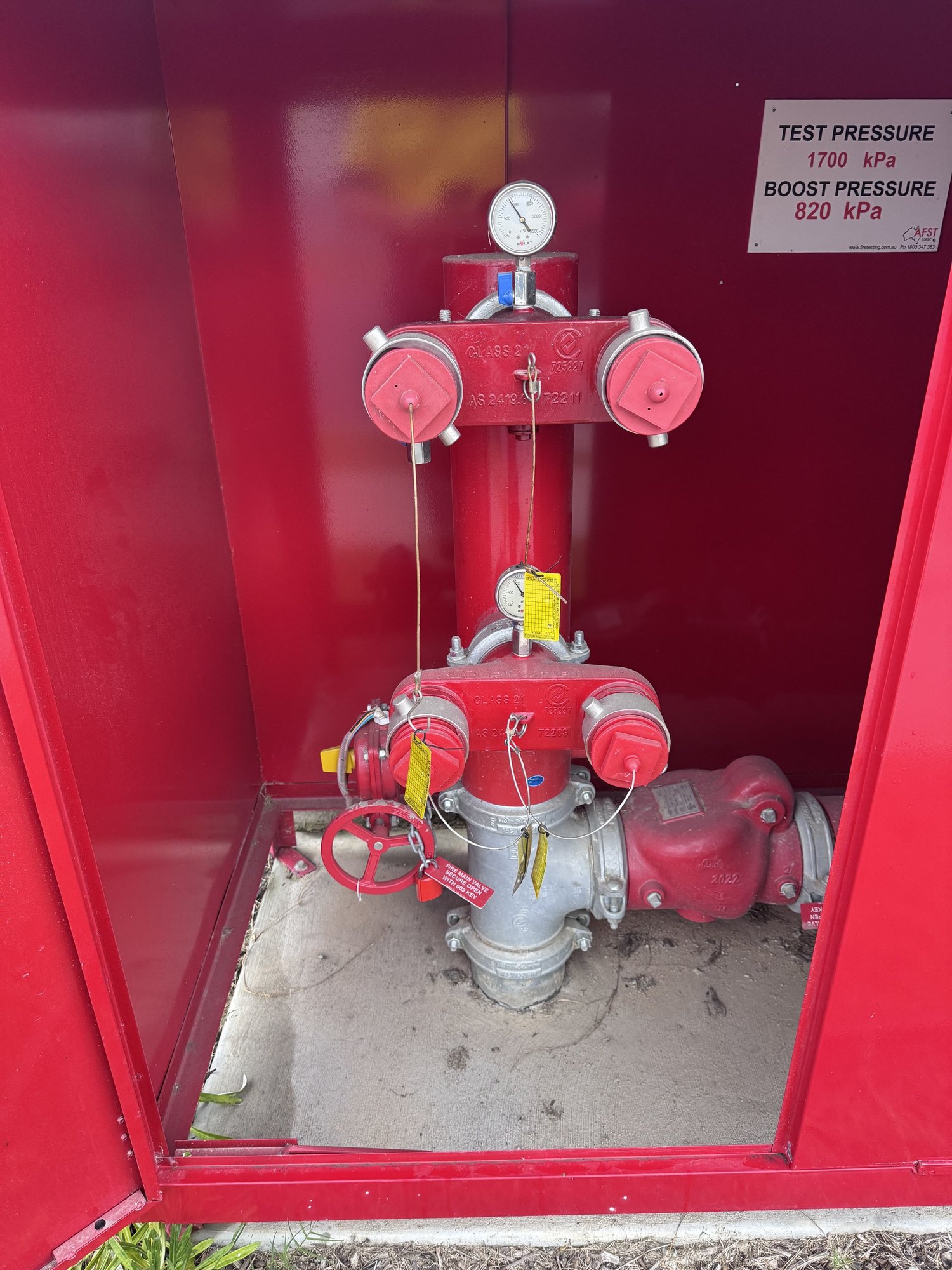 Fire hydrant booster assembly with pressure gauges during compliance testing
