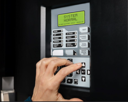 Safe QLD technician testing a fire indicator panel showing system normal